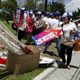 A pro-China supporter puts down a placard which reads “support universal suffrage.”